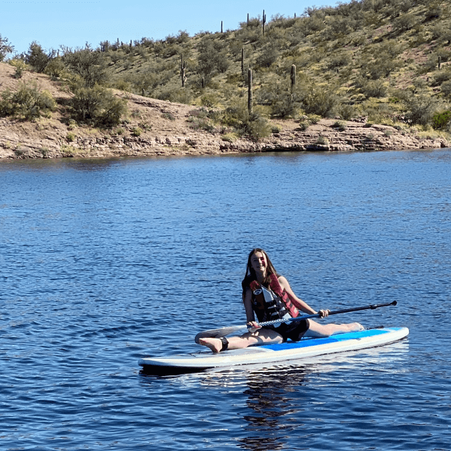 Girl on paddle board doing splits
